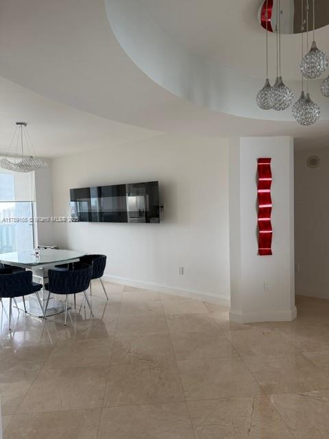 18911 Collins Avenue, Unit 2804 Sunny Isles Beach, FL 33160 - Photo 36 of 38 a living room with furniture and a potted plant