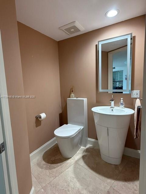 18911 Collins Avenue, Unit 2804 Sunny Isles Beach, FL 33160 - Photo 38 of 38 a bathroom with a sink and a toilet