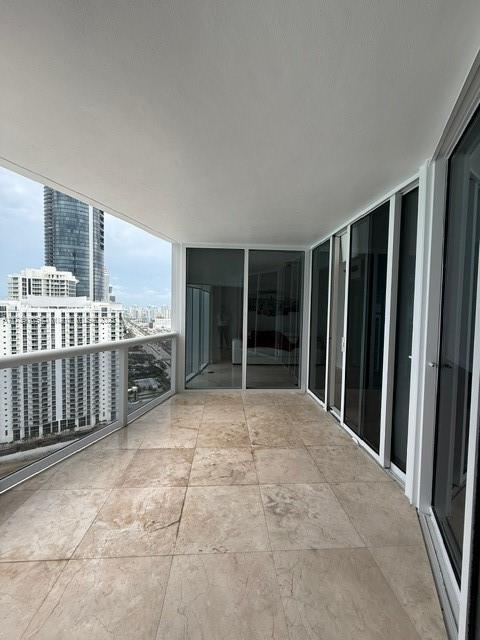 18911 Collins Avenue, Unit 2804 Sunny Isles Beach, FL 33160 - Photo 4 of 38 a view of an empty room with a balcony