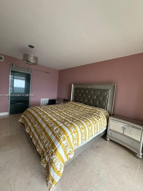 18911 Collins Avenue, Unit 2804 Sunny Isles Beach, FL 33160 - Photo 5 of 38 a bedroom with a bed and a mirror