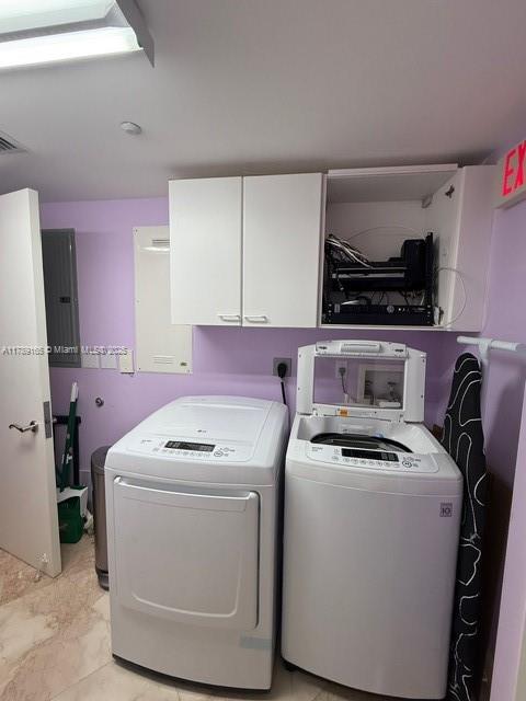 18911 Collins Avenue, Unit 2804 Sunny Isles Beach, FL 33160 - Photo 10 of 38 a utility room with dryer washer and a view of living room