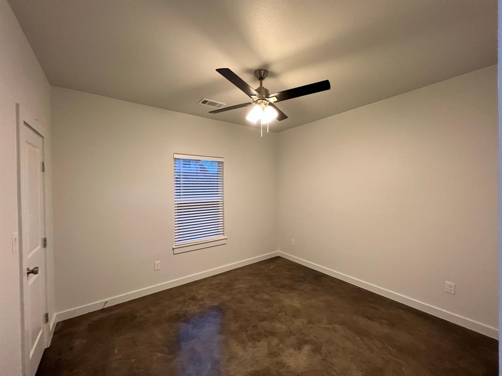 402 North Elliott Avenue Sherman, TX 75090 - Photo 12 of 19 an empty room with a window and a ceiling fan