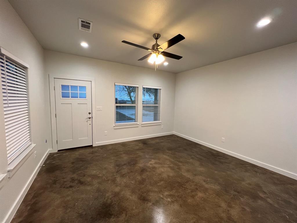 402 North Elliott Avenue Sherman, TX 75090 - Photo 2 of 19 an empty room with windows and fan