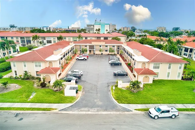 a view of a white house with a yard patio and fire pit