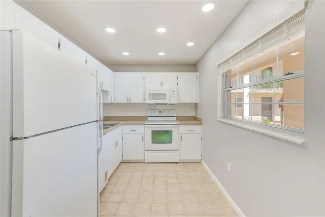 a white refrigerator freezer sitting in a kitchen