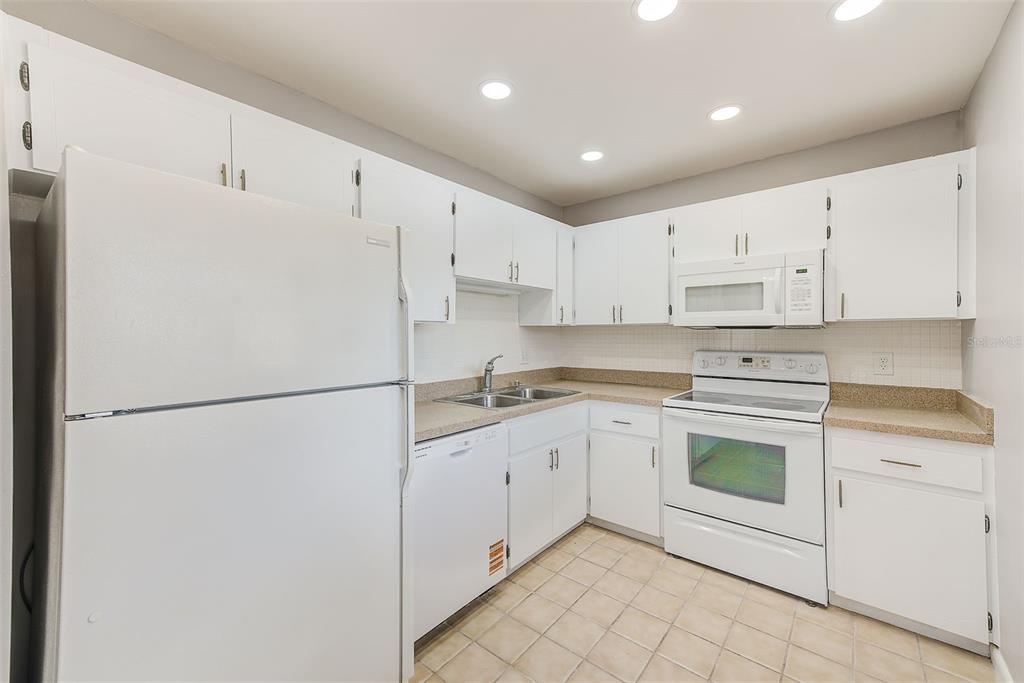 10280 Imperial Point Drive West, Unit 7 Largo, FL 33774 - Photo 21 of 51 a white refrigerator freezer sitting in a kitchen