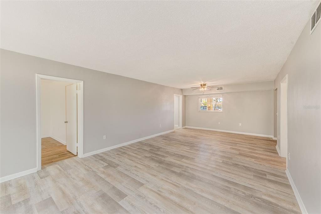10280 Imperial Point Drive West, Unit 7 Largo, FL 33774 - Photo 23 of 51 a view of empty room with wooden floor