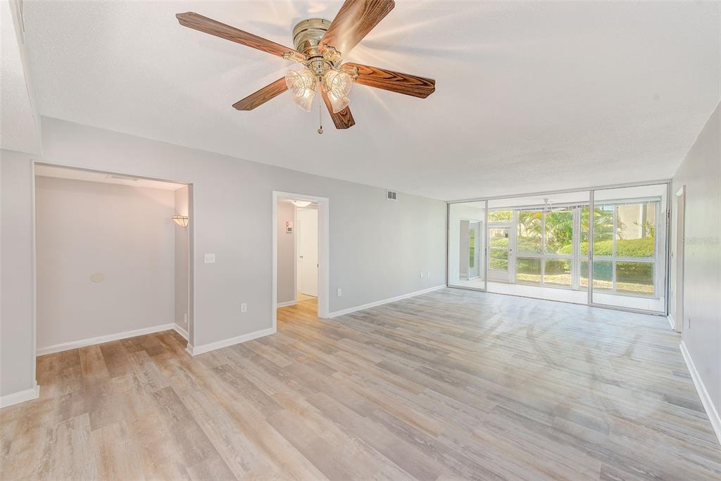 10280 Imperial Point Drive West, Unit 7 Largo, FL 33774 - Photo 25 of 51 a view of an empty room with a window and wooden floor