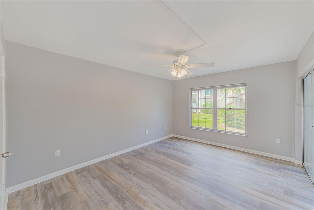 10280 Imperial Point Drive West, Unit 7 Largo, FL 33774 - Photo 29 of 51 a view of an empty room with wooden floor and a window