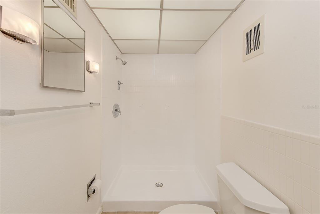 10280 Imperial Point Drive West, Unit 7 Largo, FL 33774 - Photo 31 of 51 a bathroom with a shower a toilet and sink
