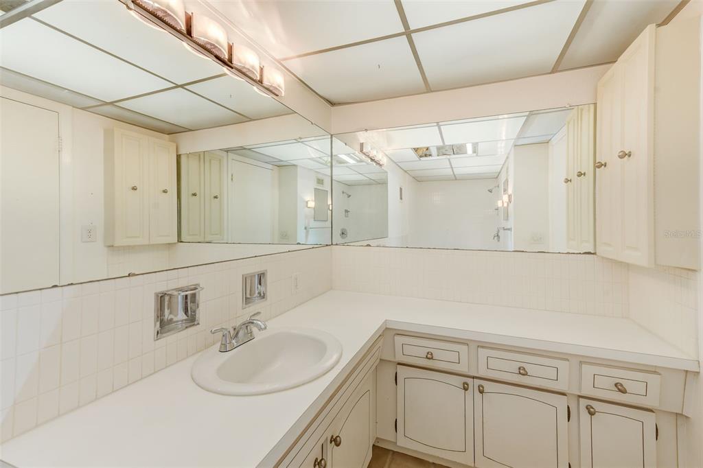 10280 Imperial Point Drive West, Unit 7 Largo, FL 33774 - Photo 32 of 51 a bathroom with a sink vanity granite and a mirror