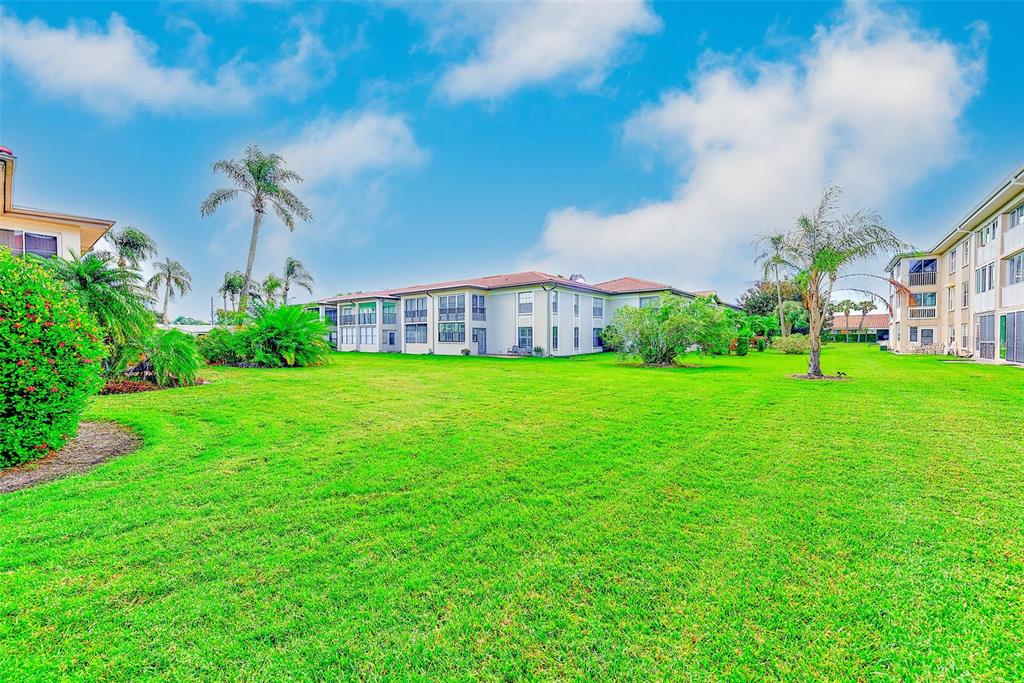 10280 Imperial Point Drive West, Unit 7 Largo, FL 33774 - Photo 35 of 51 a view of a garden with a house in the background