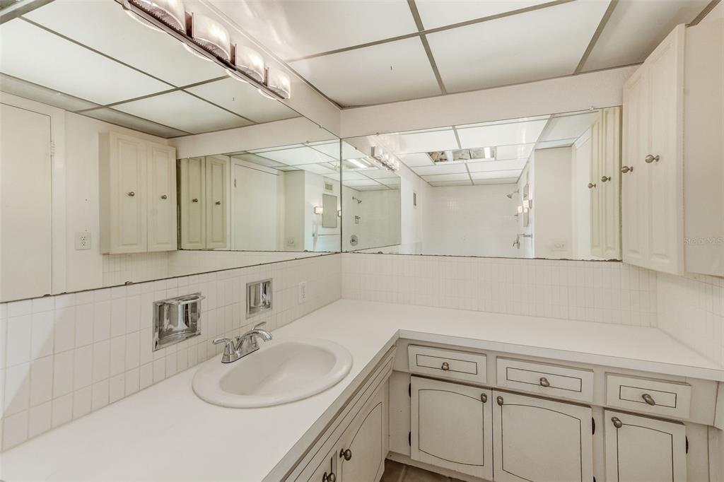 10280 Imperial Point Drive West, Unit 7 Largo, FL 33774 - Photo 49 of 51 a bathroom with a sink vanity granite and a mirror