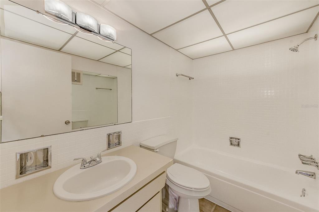 10280 Imperial Point Drive West, Unit 7 Largo, FL 33774 - Photo 50 of 51 a bathroom with a sink toilet and shower