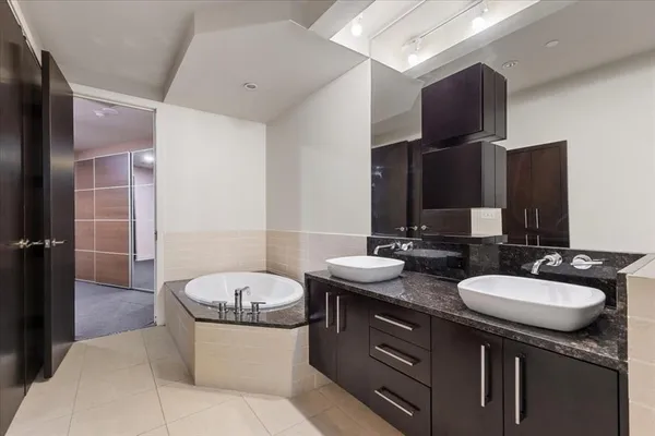 a bathroom with a double vanity sink and mirror