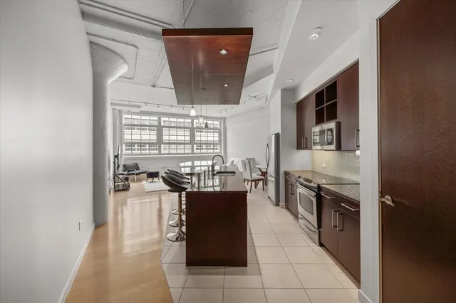 a kitchen with stainless steel appliances a stove a sink and a refrigerator