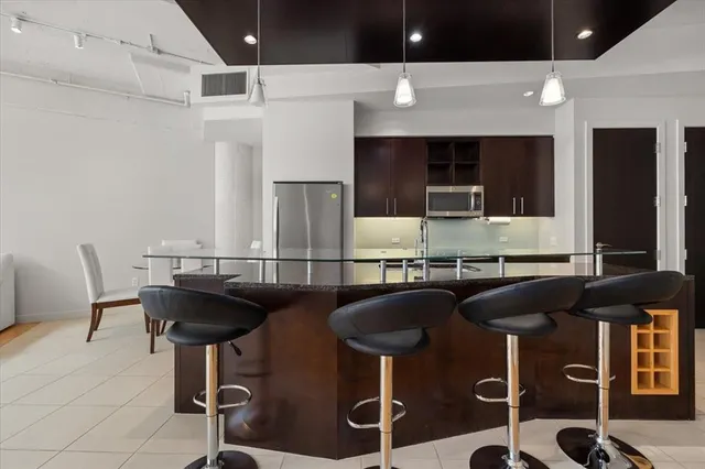 a kitchen with stainless steel appliances granite countertop a stove and a sink