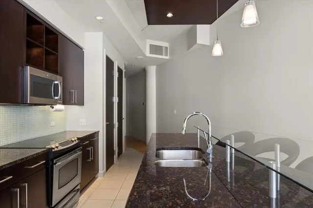 a kitchen with stainless steel appliances granite countertop a stove and a sink