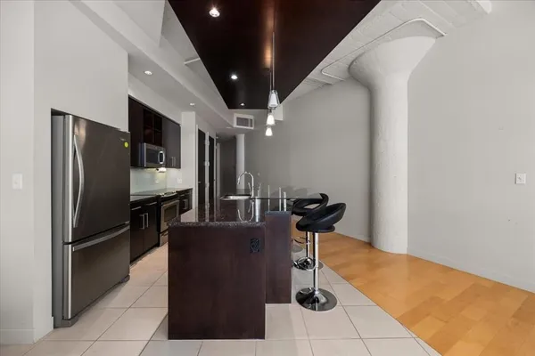 a kitchen with granite countertop a stove and a sink