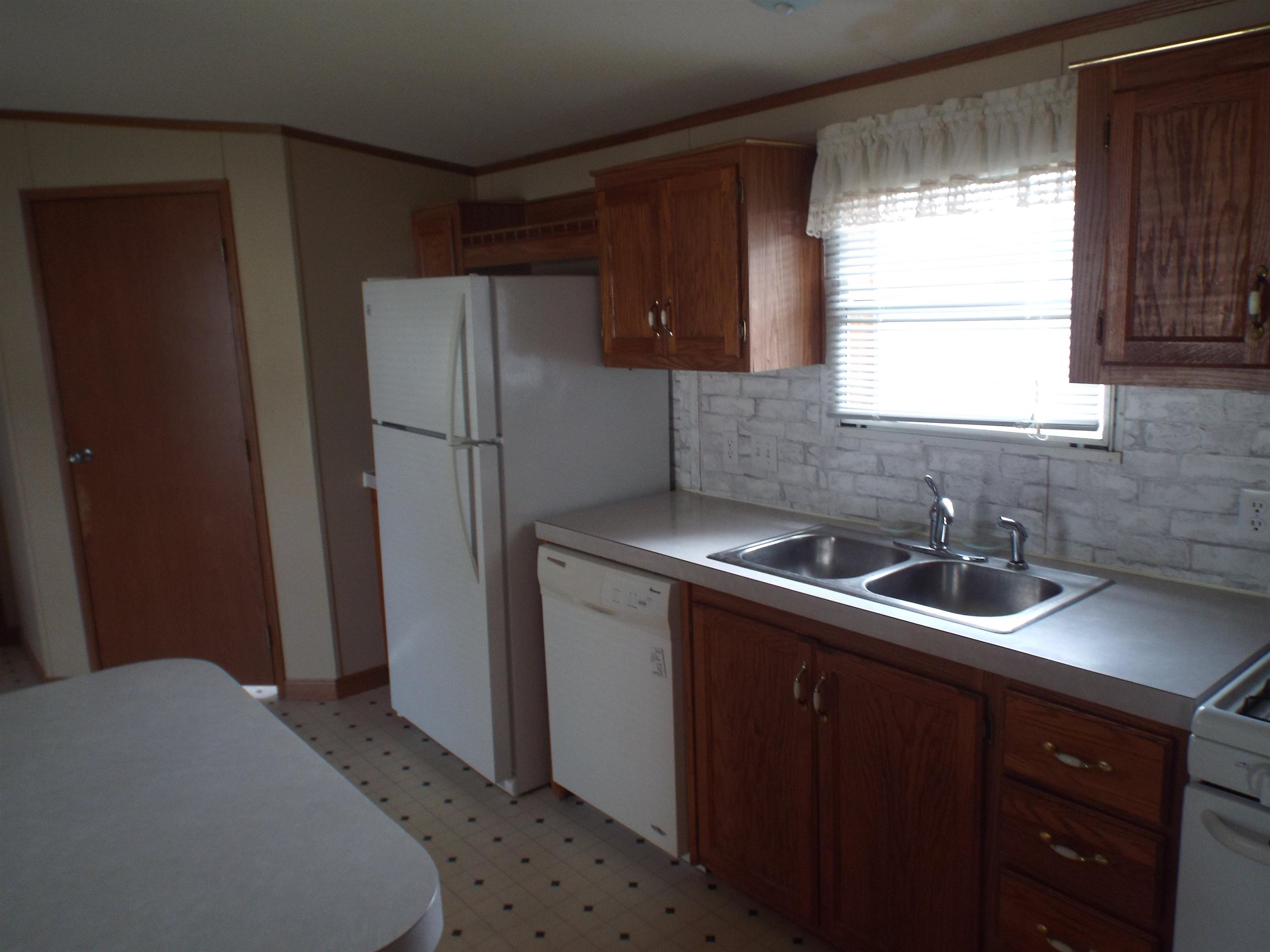 108 Starlight Drive Freeport, IL 61032 - Photo 2 of 19 a kitchen with a sink a refrigerator and window