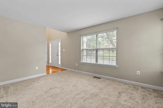 a view of a livingroom with a chandelier furniture and windows