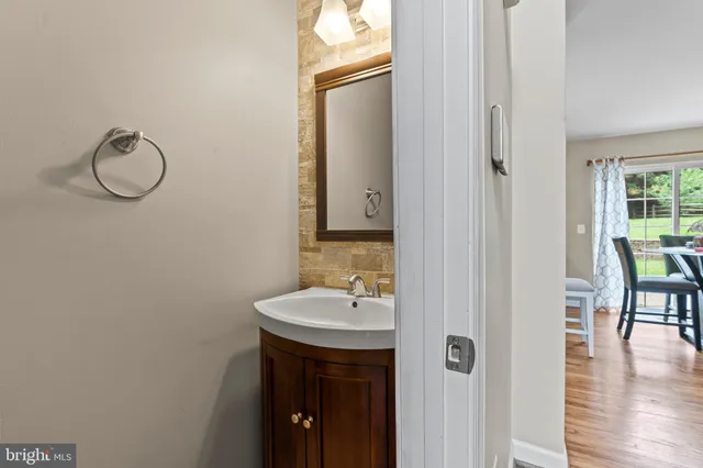 a view of entryway and hall with wooden floor