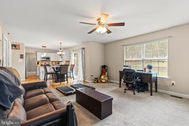 a view of an empty room with a ceiling fan