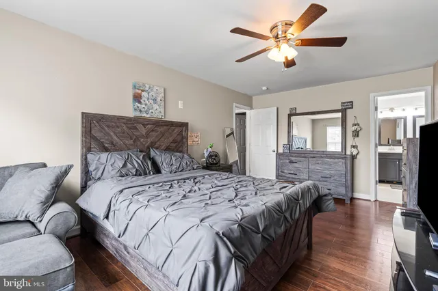 a spacious bathroom with a tub sink and mirror