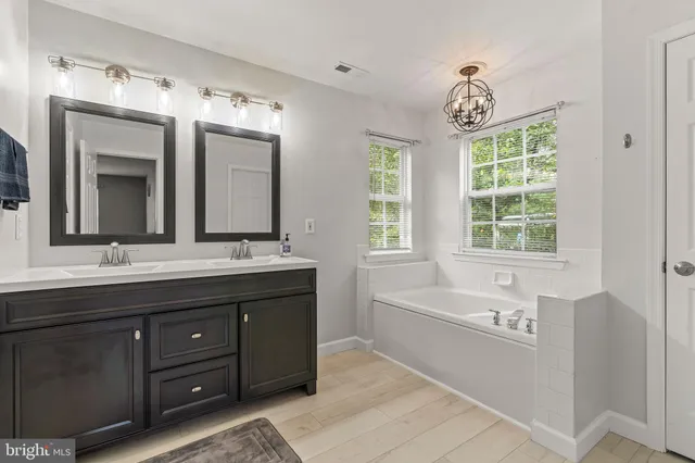 a bathroom with a double vanity sink and mirror