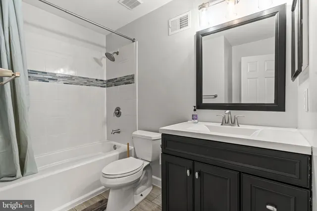 a living room with furniture a rug and a window