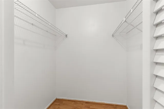 a view of room with wooden floor and ceiling fan