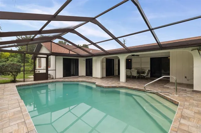 a view of a house with a yard and potted plants