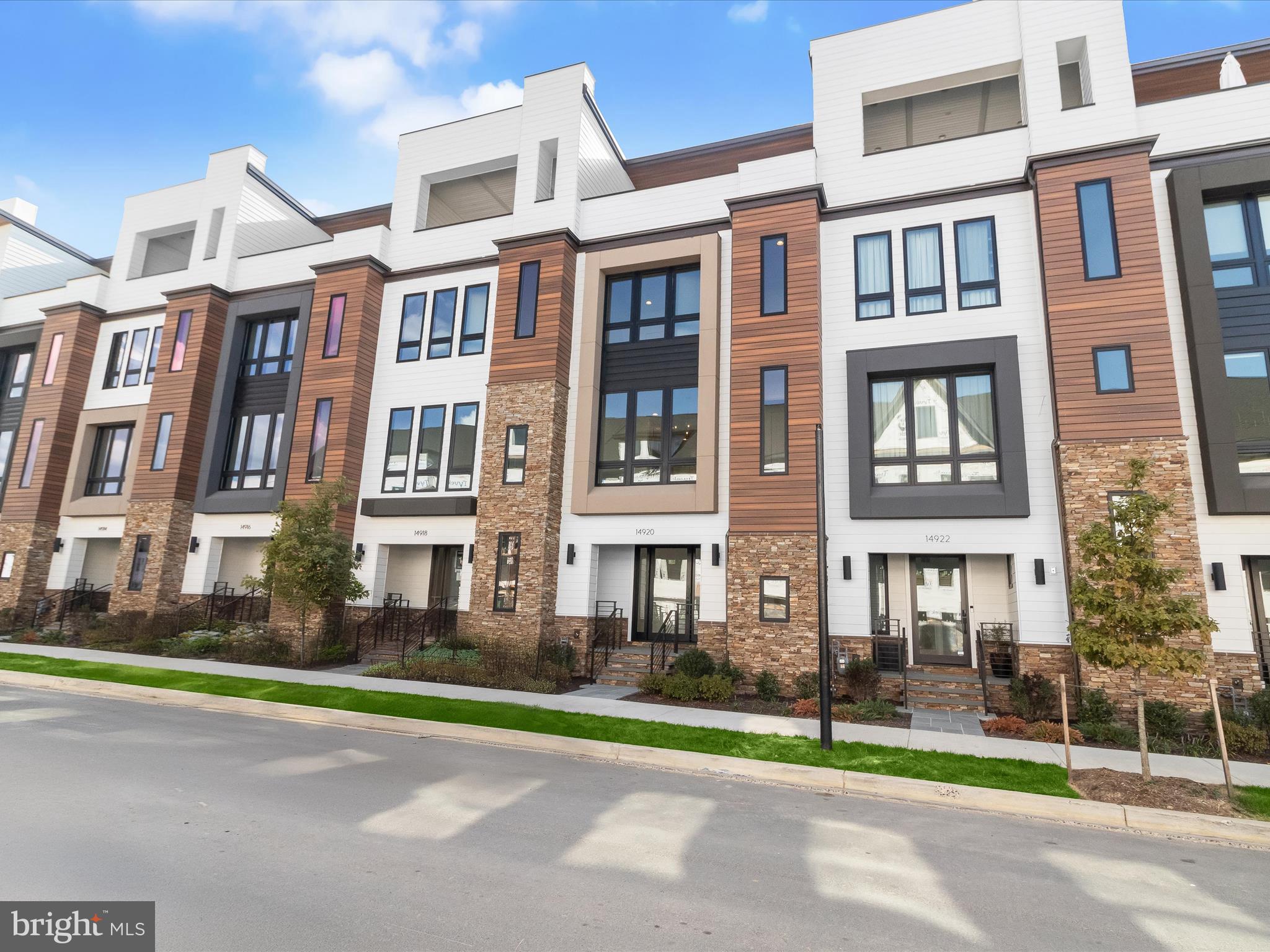 a city view of a brick building next to a yard