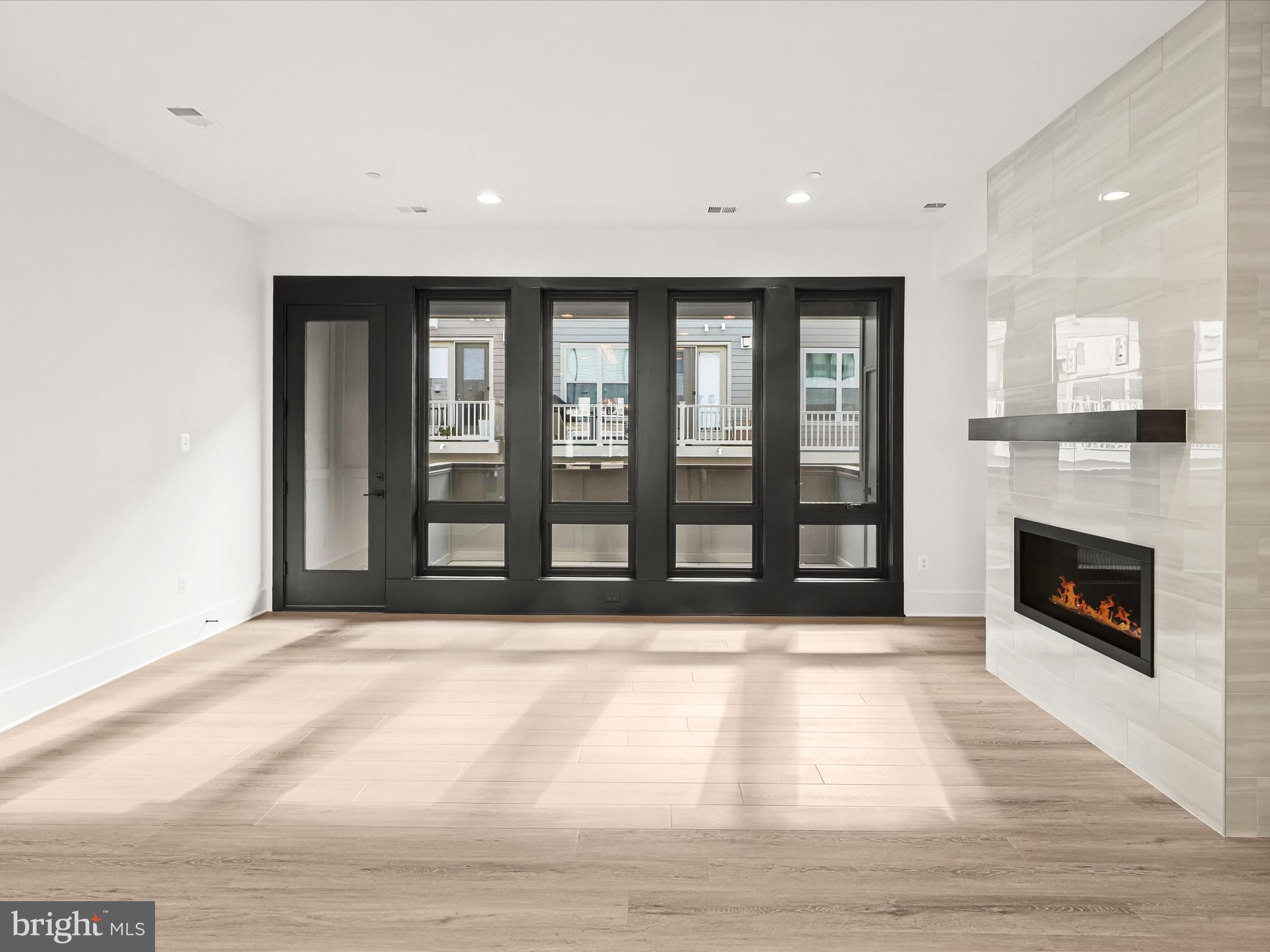 14920 Dispatch Street Rockville, MD 20850 - Photo 14 of 85 a view of an empty room with a fireplace and a window