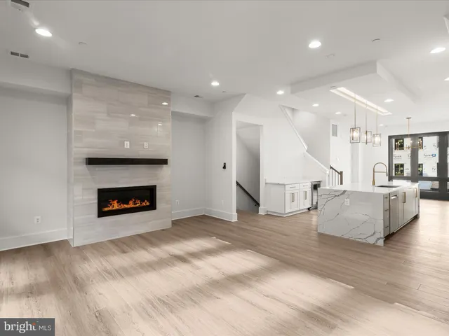 a large white kitchen with a large window