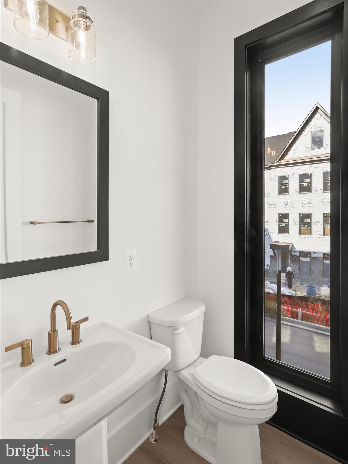 14920 Dispatch Street Rockville, MD 20850 - Photo 30 of 85 a bathroom with a toilet sink and mirror