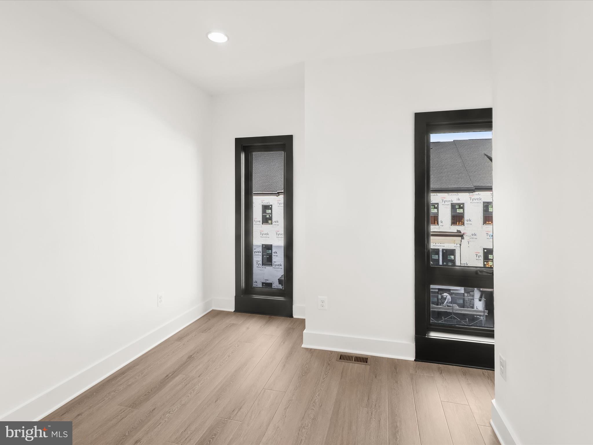 14920 Dispatch Street Rockville, MD 20850 - Photo 51 of 85 a view of an empty room with wooden floor