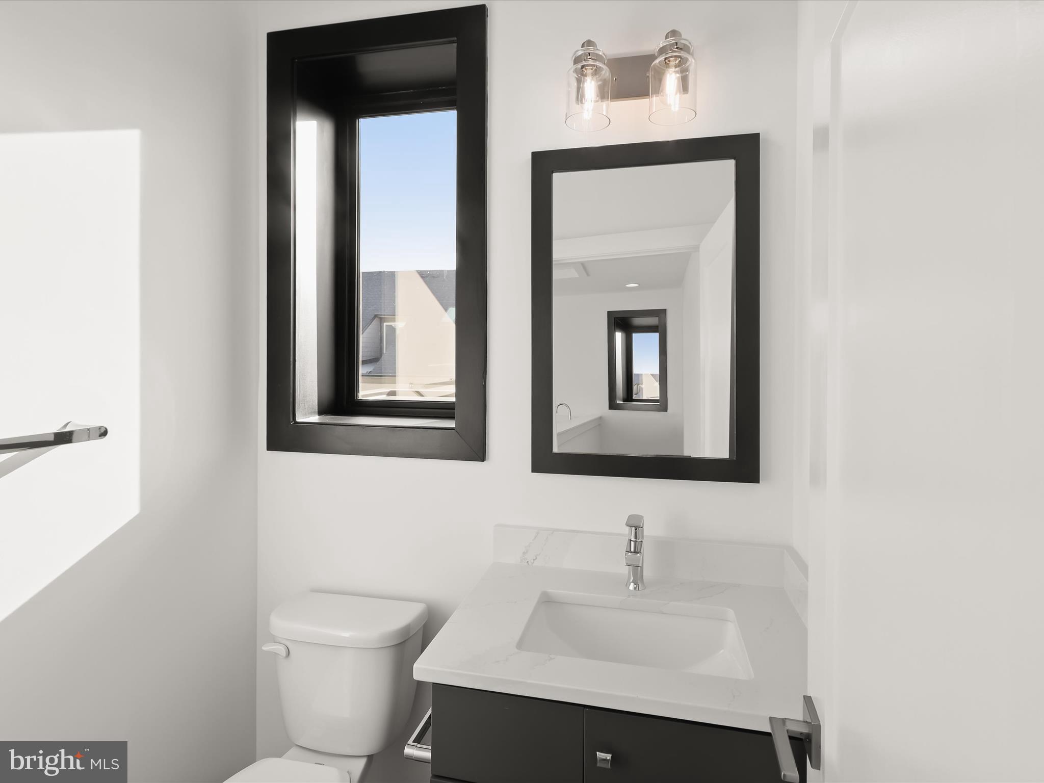 14920 Dispatch Street Rockville, MD 20850 - Photo 58 of 85 a bathroom with a toilet sink and mirror