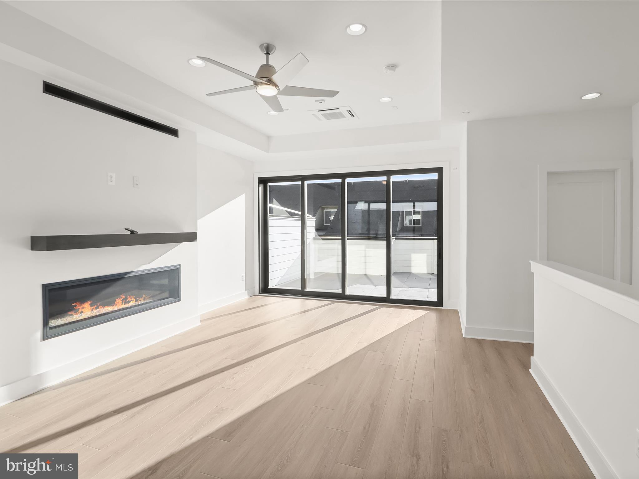 14920 Dispatch Street Rockville, MD 20850 - Photo 63 of 85 a view of an empty room with wooden floor fireplace and a window