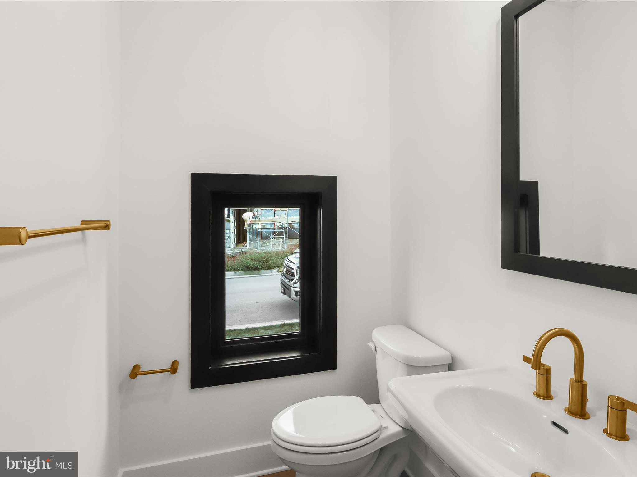 14920 Dispatch Street Rockville, MD 20850 - Photo 7 of 85 a bathroom with a toilet sink and mirror