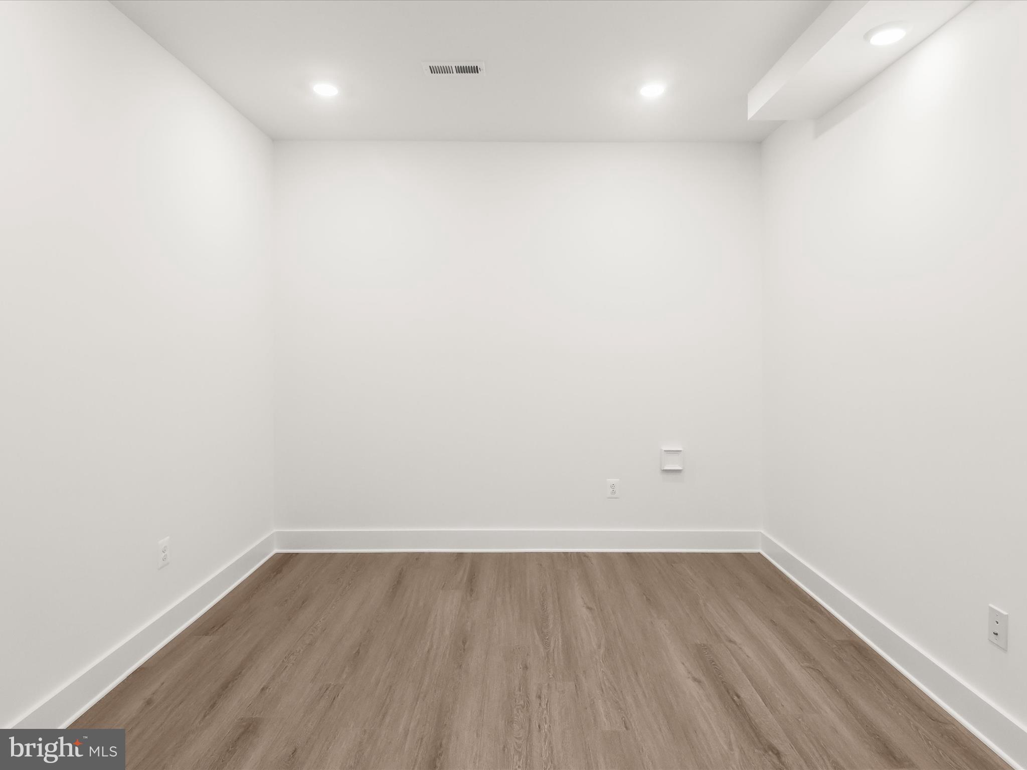 14920 Dispatch Street Rockville, MD 20850 - Photo 9 of 85 a view of room with wooden floor and window