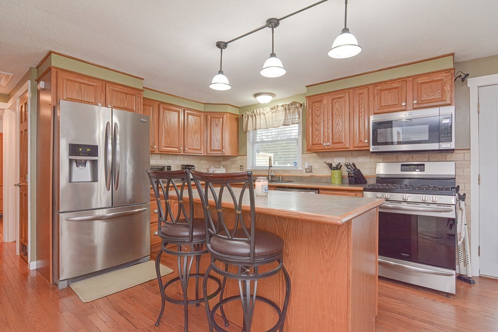 321 Grand Valley Road Springfield, MA 01128 - Photo 8 of 38 a kitchen with stainless steel appliances granite countertop a refrigerator and a stove top oven