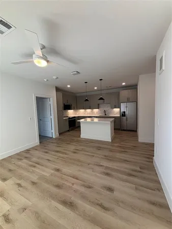 a view of a kitchen with a sink and a refrigerator