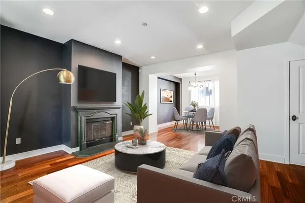 a living room with fireplace furniture and a flat screen tv