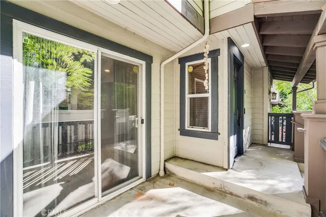 a view of a porch with a floor to ceiling window