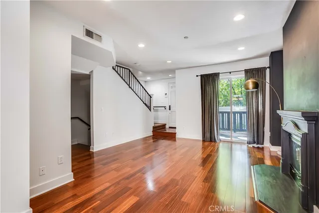 a view of a living room with hardwood floor and a ceiling fan