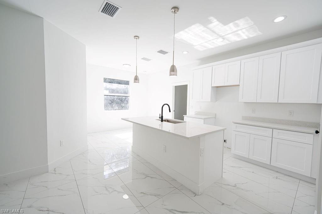 241 Novia Lehigh Acres, FL 33974 - Photo 18 of 28 a kitchen with a sink window and cabinets