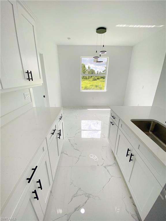 241 Novia Lehigh Acres, FL 33974 - Photo 2 of 28 a bathroom with a sink a vanity and a mirror