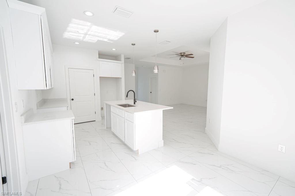 241 Novia Lehigh Acres, FL 33974 - Photo 21 of 28 a bathroom with a sink a mirror and a shower
