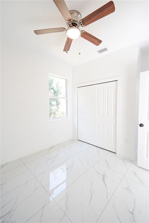 241 Novia Lehigh Acres, FL 33974 - Photo 23 of 28 an empty room with windows and fan